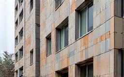 Building facade clad with unique architectural tiles